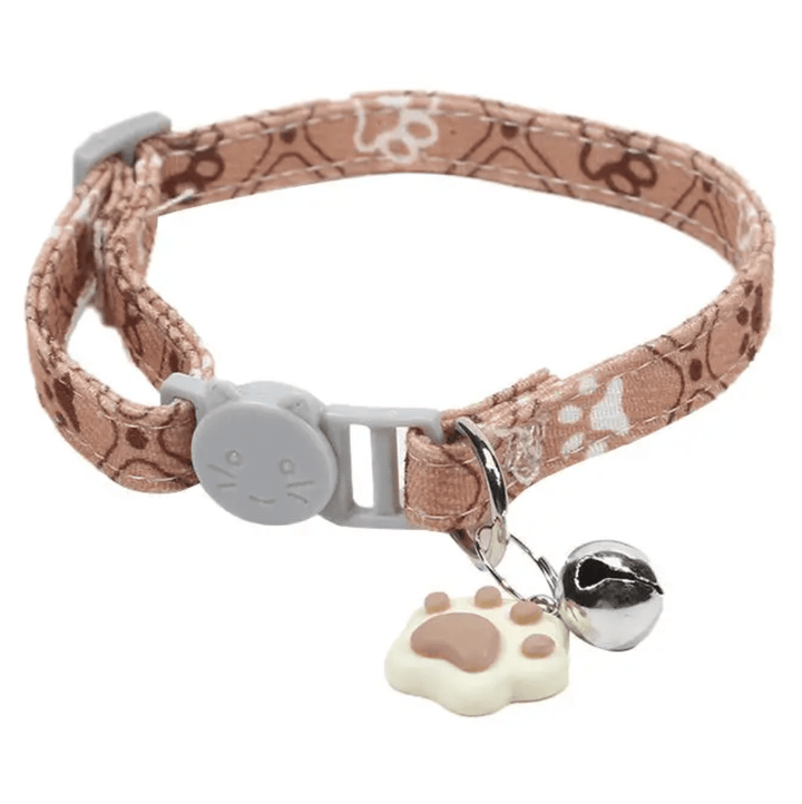 Cute pink adjustable cat collar with paw prints and safety bell for kittens and small pets.