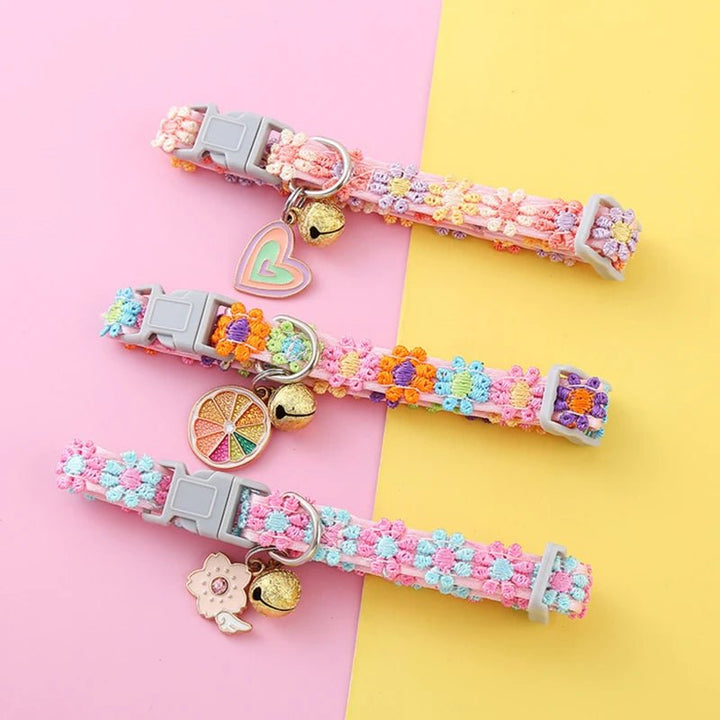 Close-up of an adjustable pet collar with a delicate floral print and tiny bell