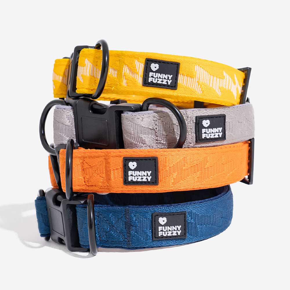Stack of folded adjustable nylon reflective dog collars. Pet accessory storage.