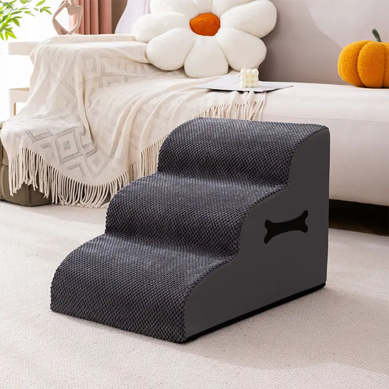 Two small dogs using the gentle ramp of adjustable soft pet stairs to reach sofa