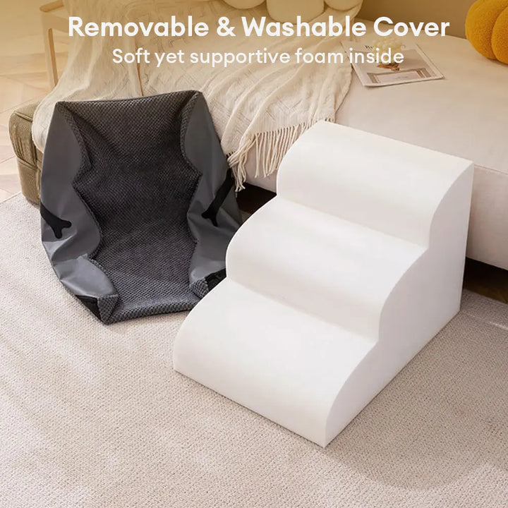 Pet dog comfortably resting on top tier of adjustable soft pet stairs with ramp
