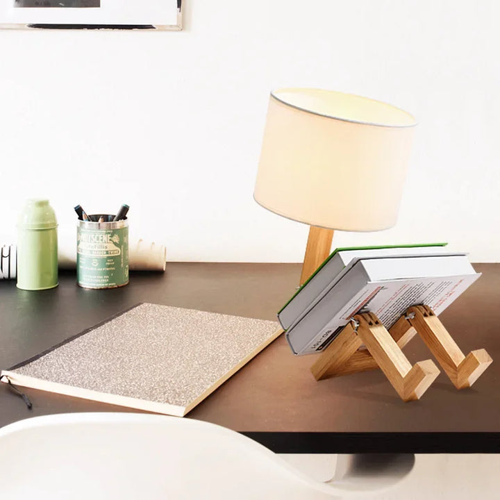 Decorative wooden robot lamp with a fabric shade, adjustable limbs, and a built-in shelf for storage.