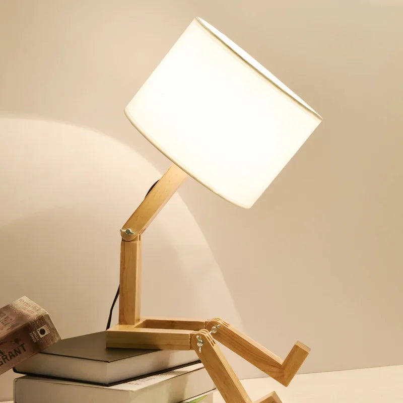 Home decor accent: clever wooden robot lamp with an adjustable light source and useful storage shelf.