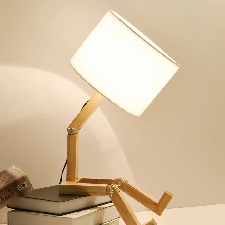 Home decor accent: clever wooden robot lamp with an adjustable light source and useful storage shelf.