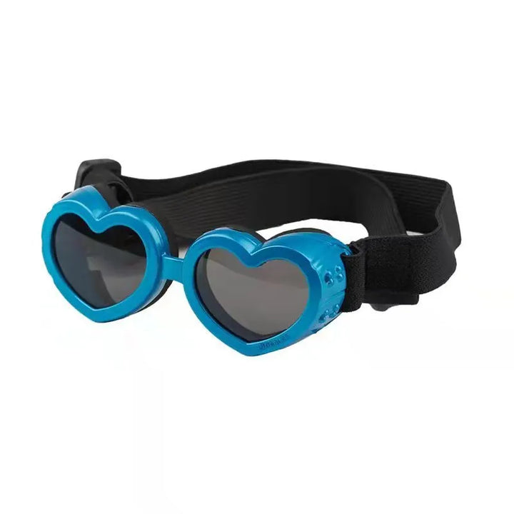 Close-up of heart-shaped dog sunglasses providing UV protection, featuring a comfortable adjustable strap.