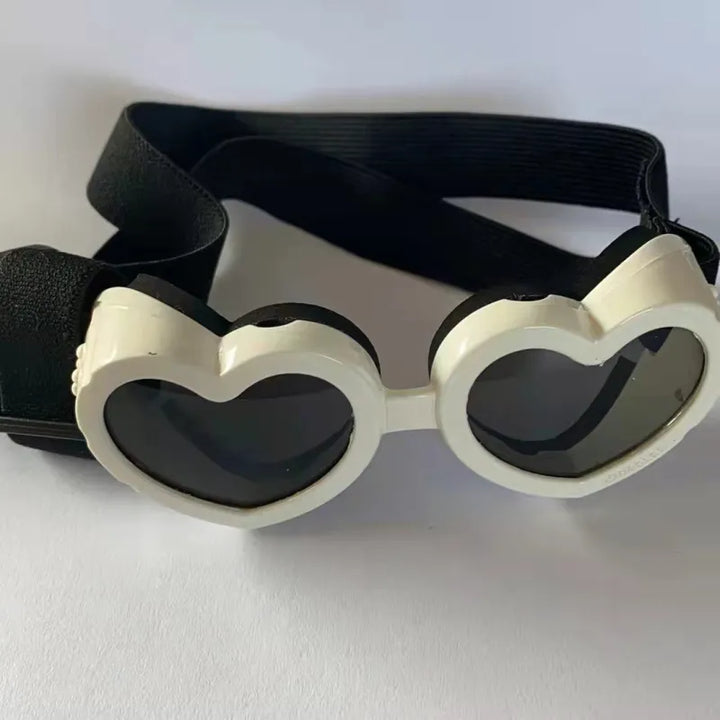 Fashionable dog sunglasses: pink heart-shaped design with UV protection, an essential pet accessory.