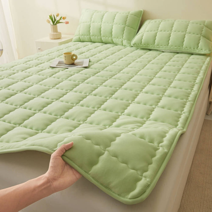 All-season breathable quilted non-slip mattress topper on a bed, showing soft texture and secure fit