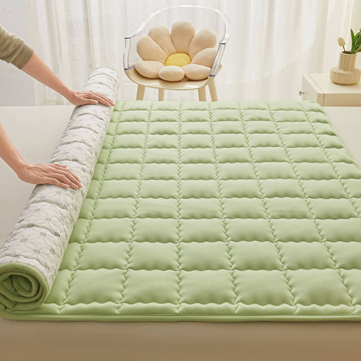 Breathable quilted mattress topper in various sizes, showcasing versatility for any bed