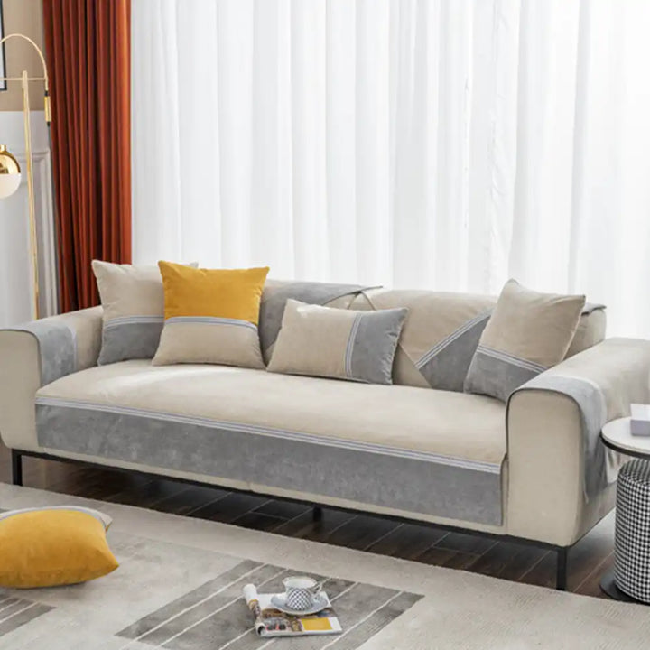 Reversible colorblock couch protector on a sofa, highlighting its versatile and durable design.