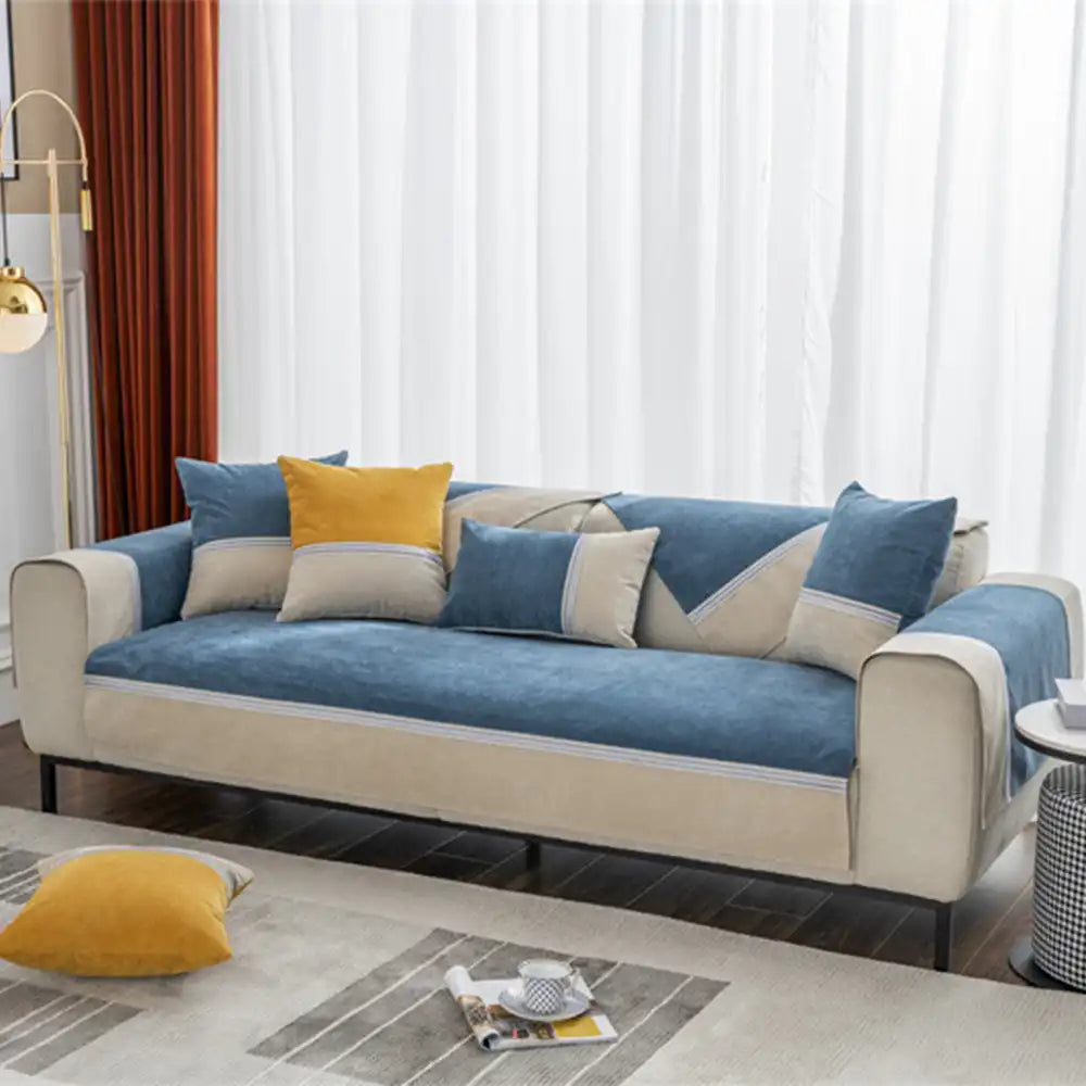 Waterproof colorblock couch cover protecting a sofa from spills, pet hair, and wear.