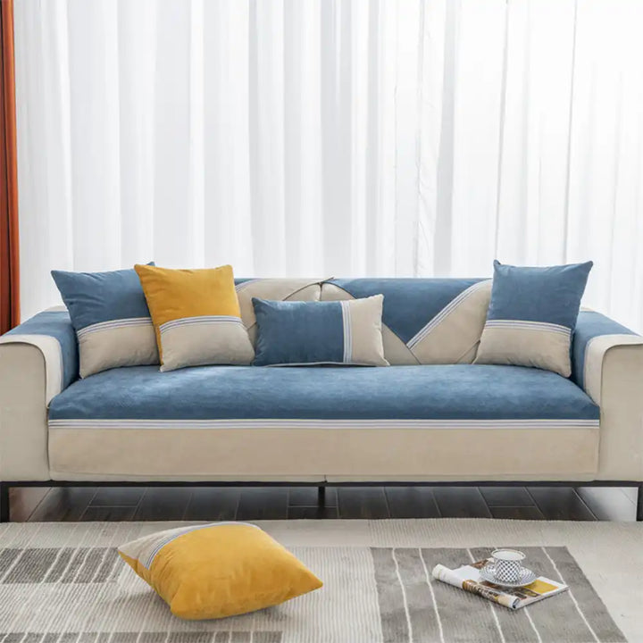 Stylish home decor using a water-resistant colorblock couch cover on a living room sofa.