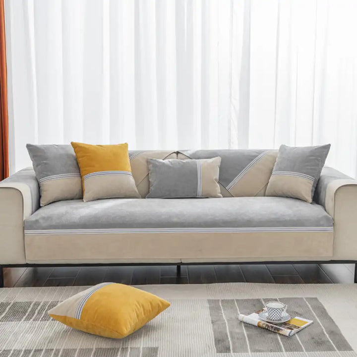 Overhead view of an anti-slip, pet-friendly colorblock couch cover fitting a three-seater sofa.