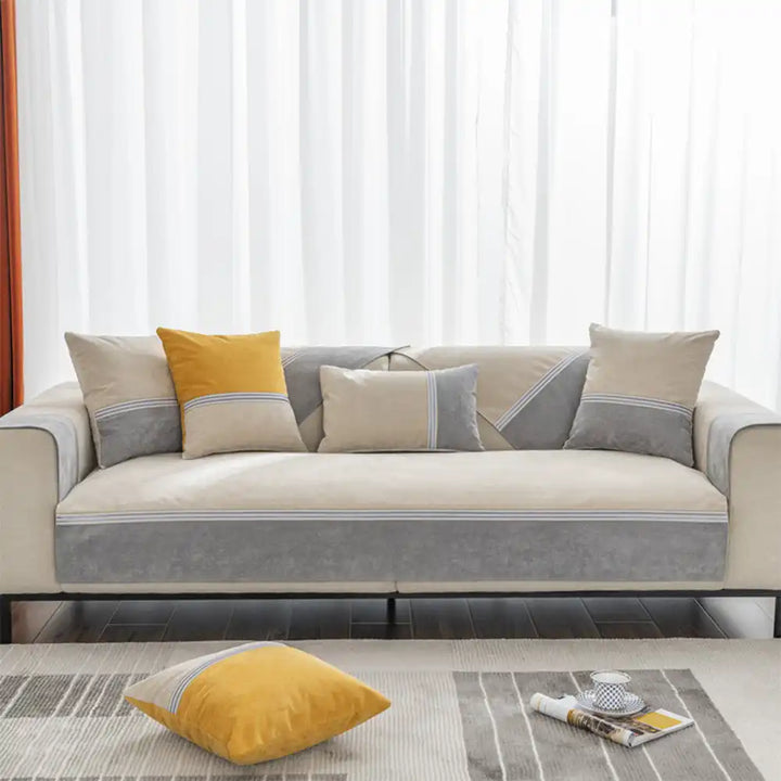 Family-friendly waterproof couch cover in colorblock design, guarding furniture from daily use.
