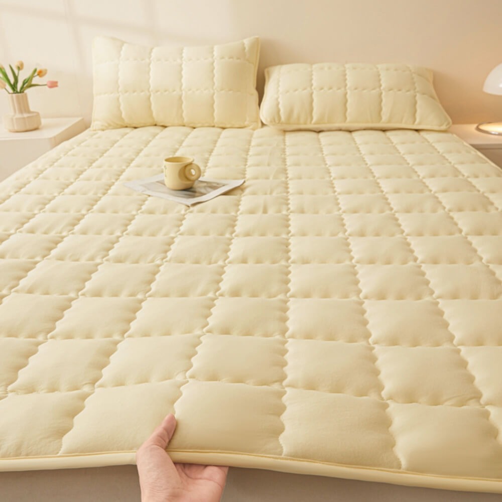 Stack of folded breathable mattress toppers, emphasizing their compact storage and versatile use