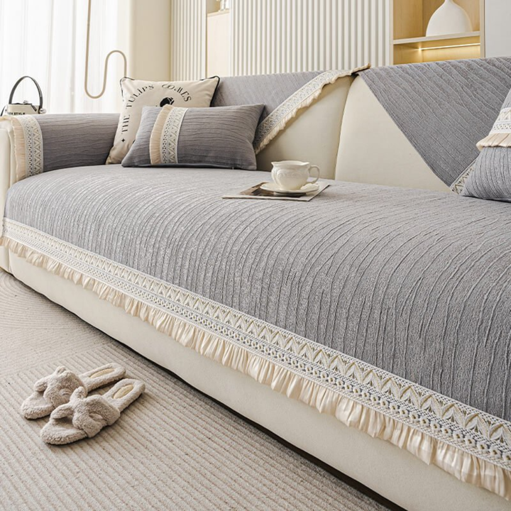 Pet-friendly anti-slip sectional sofa cover with stylish tassels, ideal for protecting furniture.
