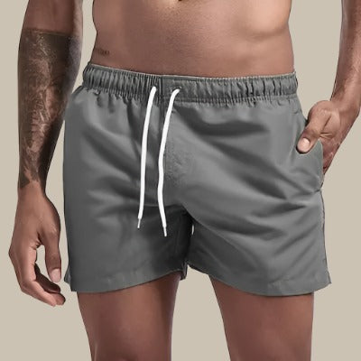 Men's quick-dry swim trunks, drawstring waist for a secure, comfortable fit.