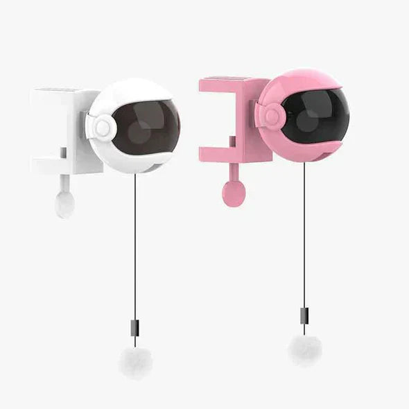 Compact automatic cat play toy on a dark floor, ideal for independent feline playtime