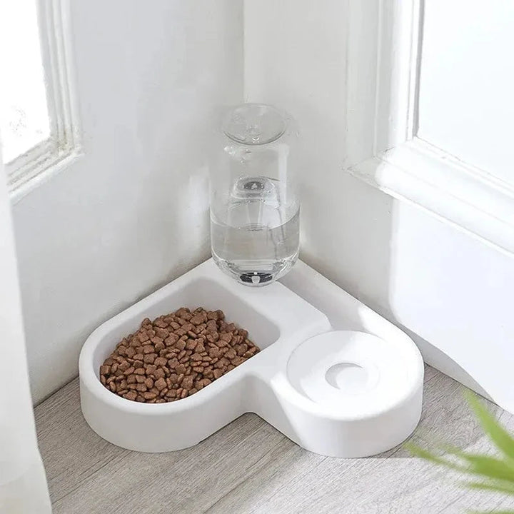 Automatic pet food and water dispenser for dogs and cats, gravity feeder ensures fresh pet supplies.