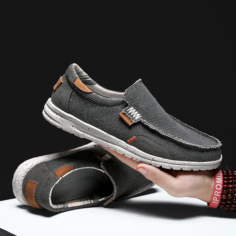 Detail of elastic gore on men's gray Dockstone slip-on canvas shoes for easy, comfortable wear.
