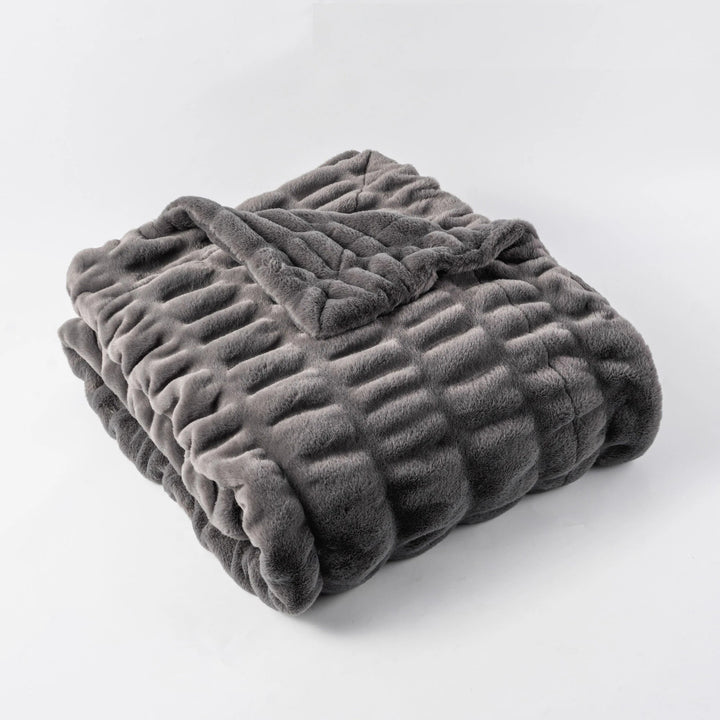 Stylish faux fur throw blanket, decorative yet cozy, perfect for modern home decor.