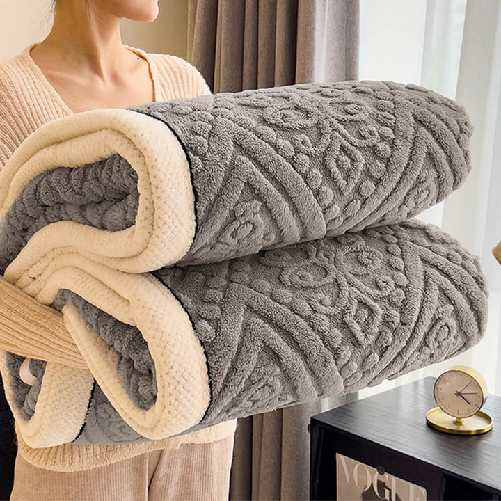 Close-up of the deep embossed pattern on a milk velvet fleece blanket, elegant Baroque style