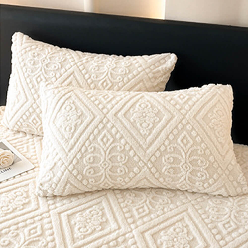 Warm and soft milk velvet fitted sheet and pillowcase set, distinguished by its baroque embossed details.