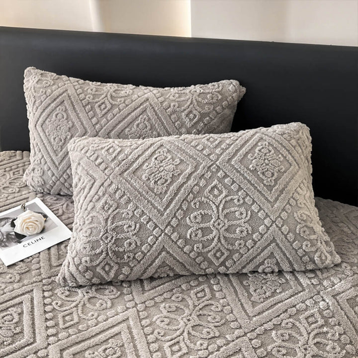 Soft-touch warm milk velvet fitted sheet for a cozy night's sleep, adorned with a baroque embossed motif.