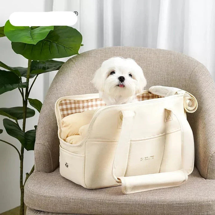 Small pet travel bag in beige, showing mesh windows for breathability.