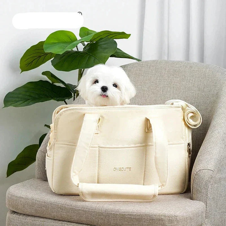 Beige pet travel bag with shoulder strap, designed for small dogs and cats.