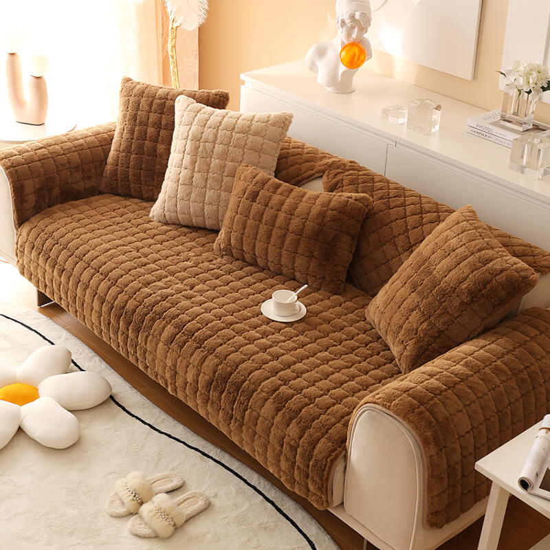 Stack of folded biscuit plush non-slip couch covers, ready for storage or use