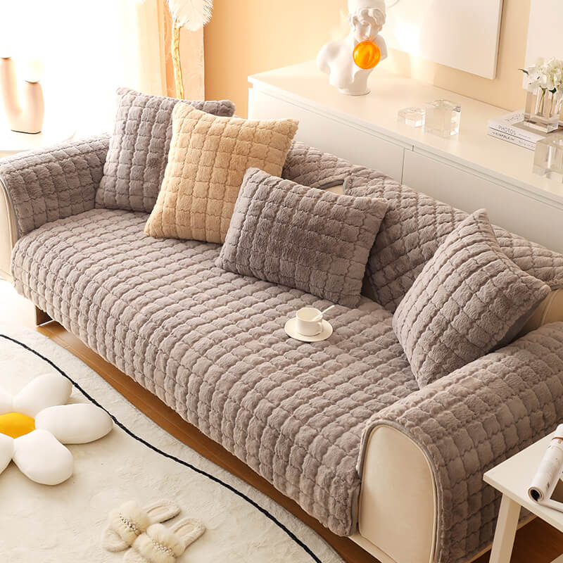 Unisex biscuit plush couch cover draped over a sectional sofa, secure non-slip design