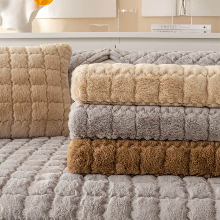 Child playing on a sofa covered with a cozy biscuit plush non-slip couch protector