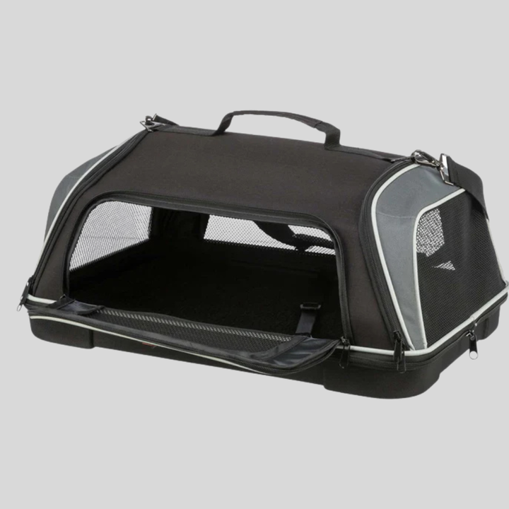 Black airline approved pet carrier, for cats and small dogs, placed under an airplane seat.