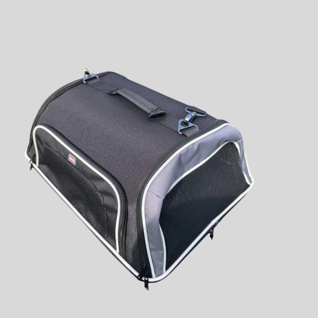 Portable pet travel carrier with shoulder strap, leash, and accessory pocket for cats and puppies.