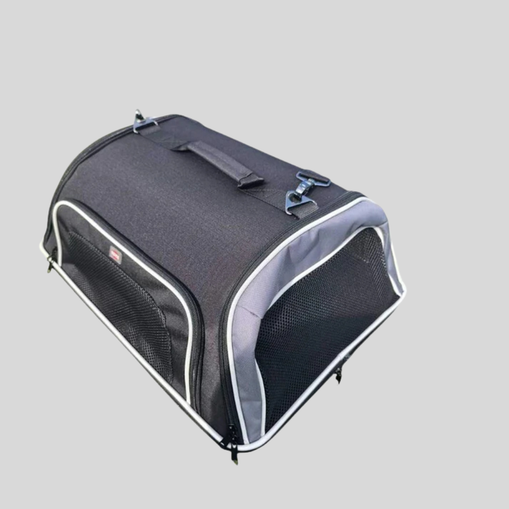 Portable pet travel carrier with shoulder strap, leash, and accessory pocket for cats and puppies.