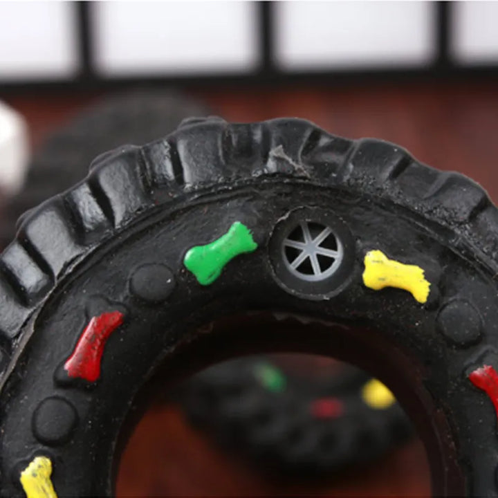 Interactive dog chew toy, black tire shape, featuring textures for dental care and engagement