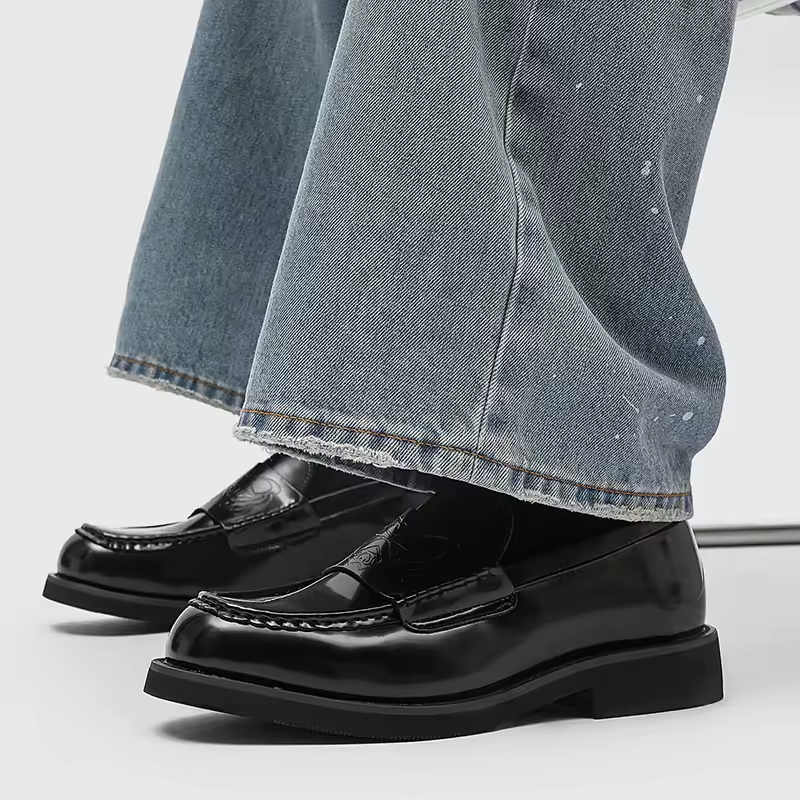 Classic black leather slip-on loafers for men, offering comfort and refined style for any occasion.
