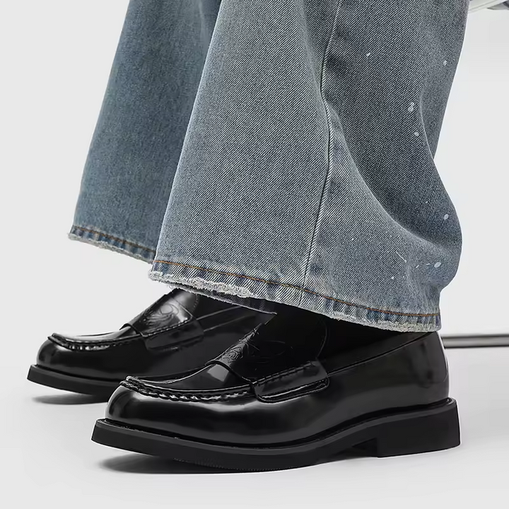 Classic black leather slip-on loafers for men, offering comfort and refined style for any occasion.