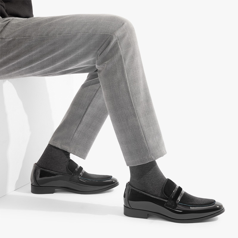 Close-up of a men's black leather dress loafer, showcasing sleek design & quality for formal style.