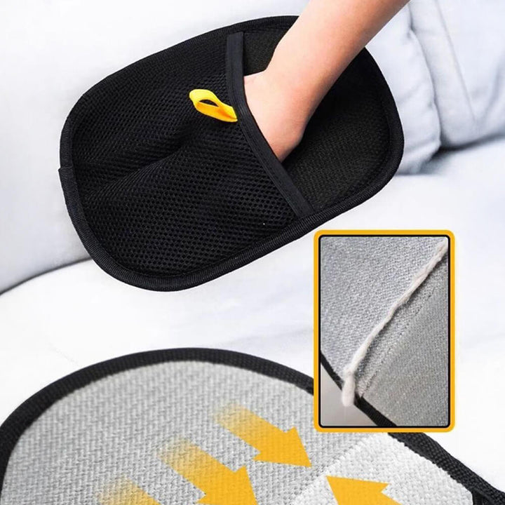 Grooming glove in black for pet hair removal, showing textured palm with bristles