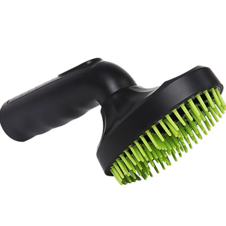 Hand holding a black pet hair vacuum attachment, demonstrating its ergonomic design for home cleaning.