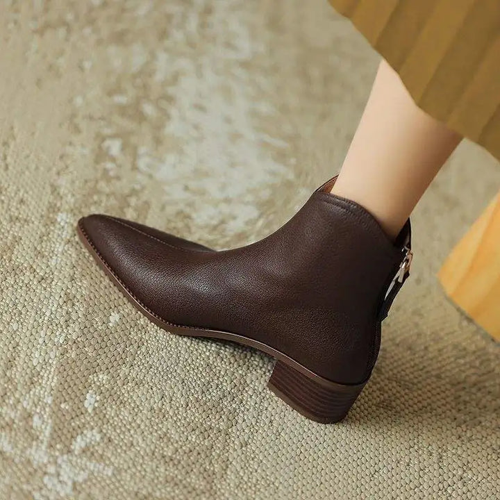 Side view of elegant women's slip-on pointed toe ankle boots with comfortable low block heel. Versatile.