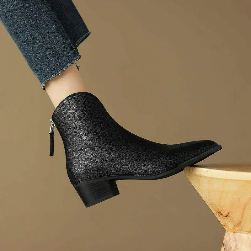 Back view of sleek women's low heel pointed toe slip-on ankle boots. Comfortable everyday & winter boots.