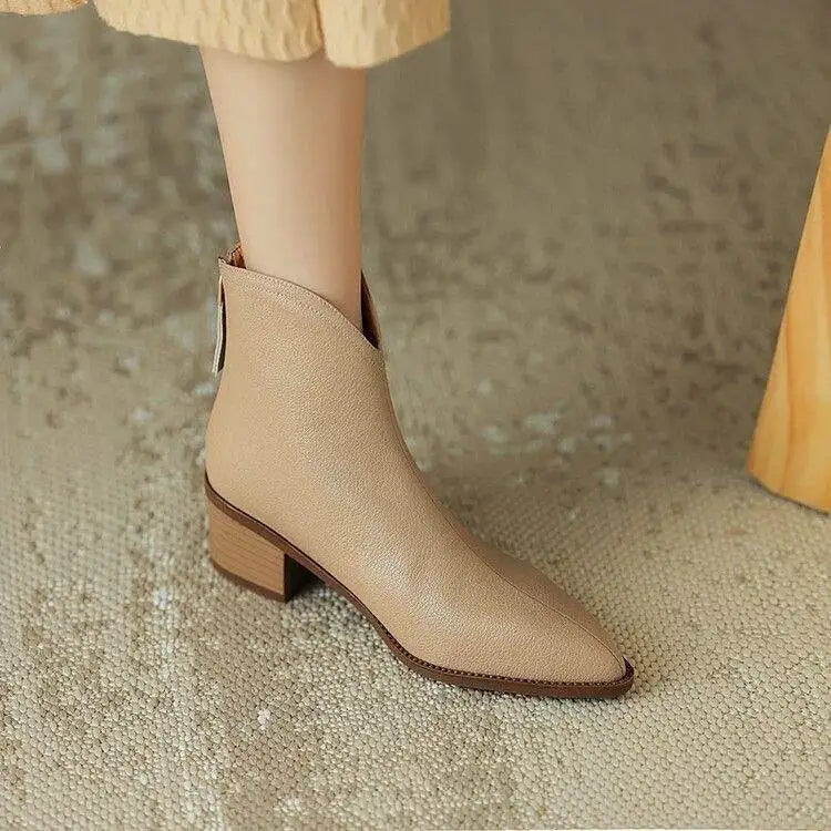 Woman walking in comfortable low heel pointed toe ankle boots. Chic & practical everyday, fall/winter wear.