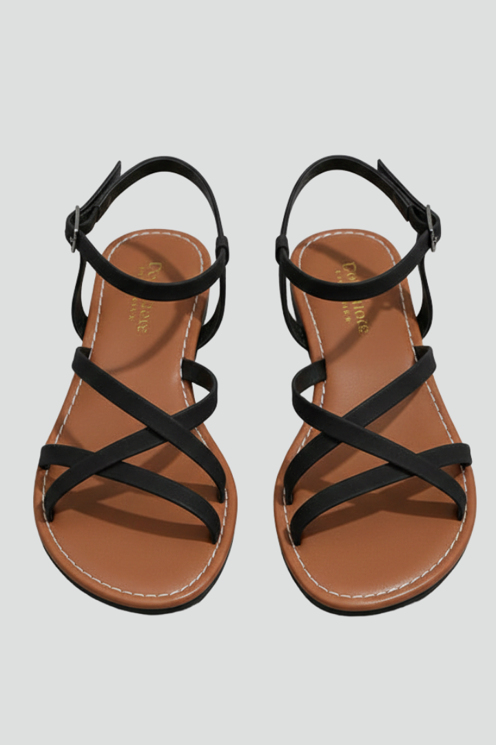 Black women's flat sandals with criss-cross straps, offering effortless comfort for chic summer and casual wear.