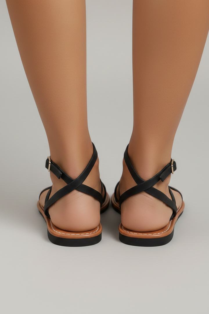 Chic black flat sandals, women's casual footwear with criss-cross straps and comfortable flat sole for summer.