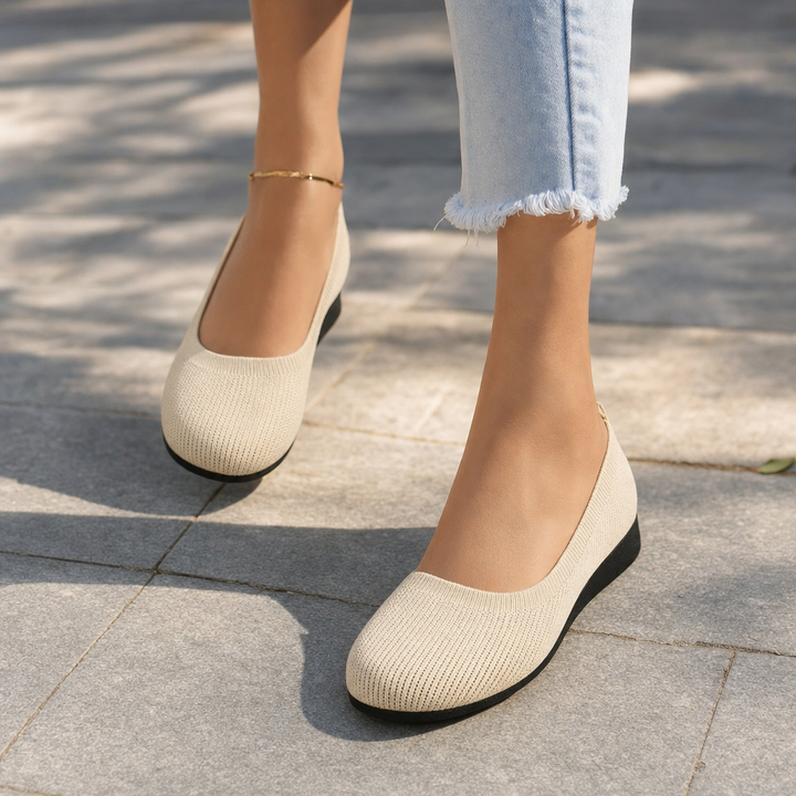 Front view of women's black orthopedic slip-on shoes, designed for ultimate walking comfort & posture support.