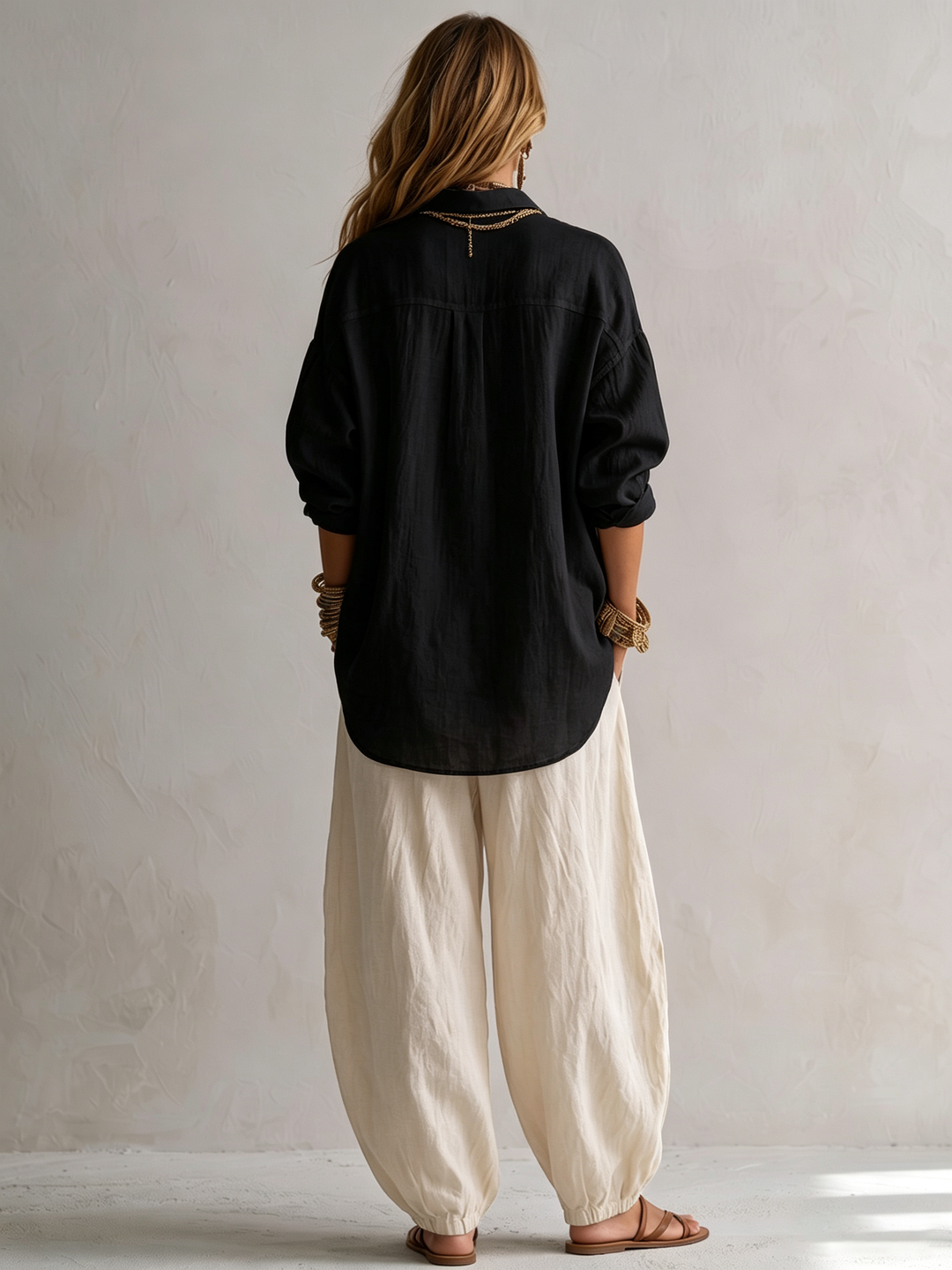 Women's casual black matching set featuring a relaxed fit button-up top and comfortable wide-leg harem pants.