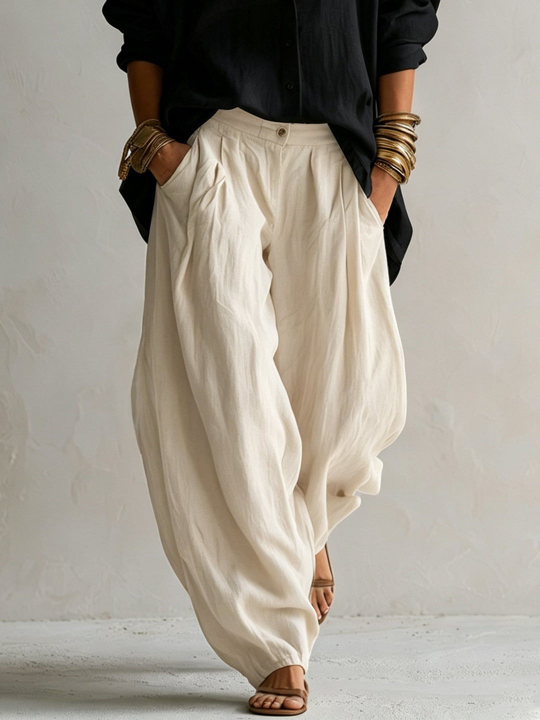 Stylish black women's two-piece set with a loose button-up shirt and flowy wide-leg pants for a relaxed look.
