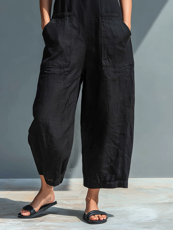 Comfortable black women's sleeveless loose-fit jumpsuit, a versatile piece for spring, summer, and travel outfits.